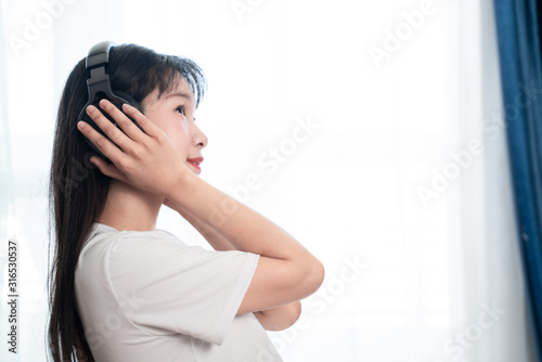asian young woman listen to the music at home