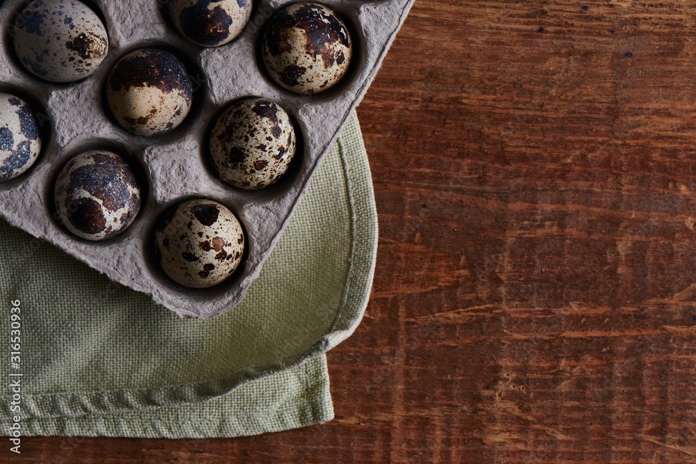 Quail eggs on wooden table decorated in a rustic style for Easter close-up with empty copy space for text Quail eggs on wooden table decorated in a rustic style for Easter close-up with empty copy space for text