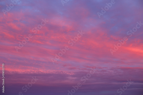 Sunset sky red clouds background © Anntuan