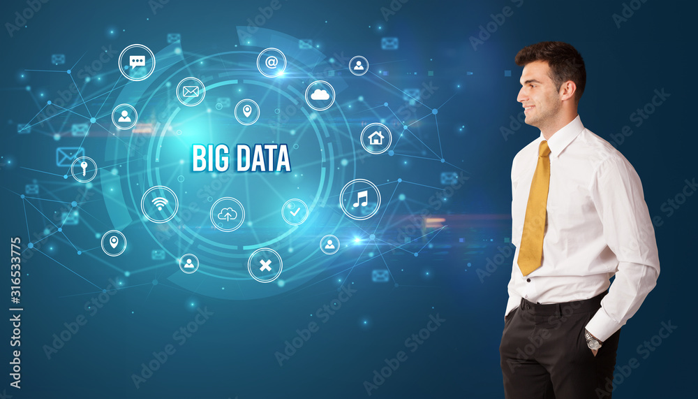 Businessman thinking in front of technology related icons and BIG DATA inscription, modern technology concept Businessman thinking in front of technology related icons and BIG DATA inscription, modern technology concept