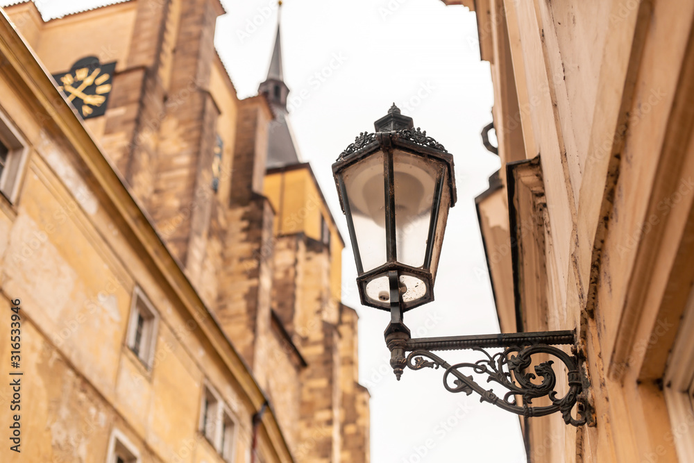 The architecture of the old city of Prague. Retro gothic street lamp for street lighting. Photo in the afternoon.