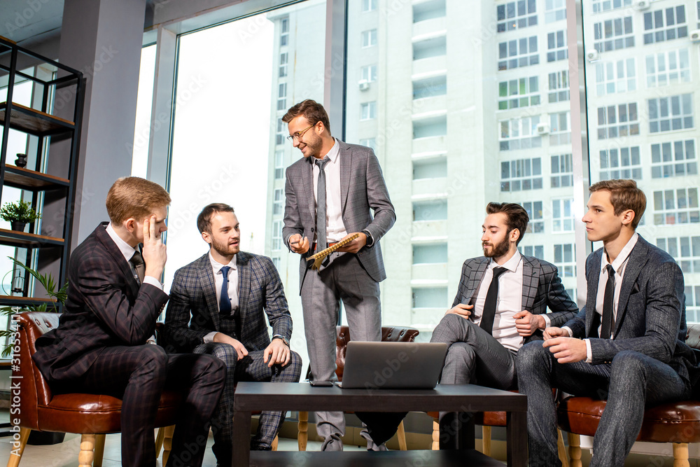 leadership and business concept. business team in modern office sit having active discussion of business ideas together, wearing tuxedo, formalwear leadership and business concept. business team in modern office sit having active discussion of business ideas together, wearing tuxedo, formalwear