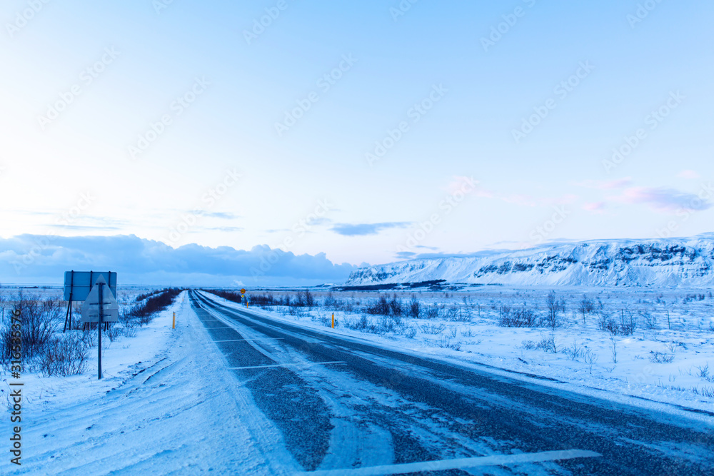 Fototapeta premium Picturesque winter landscape of Iceland. The perfect road to perspective