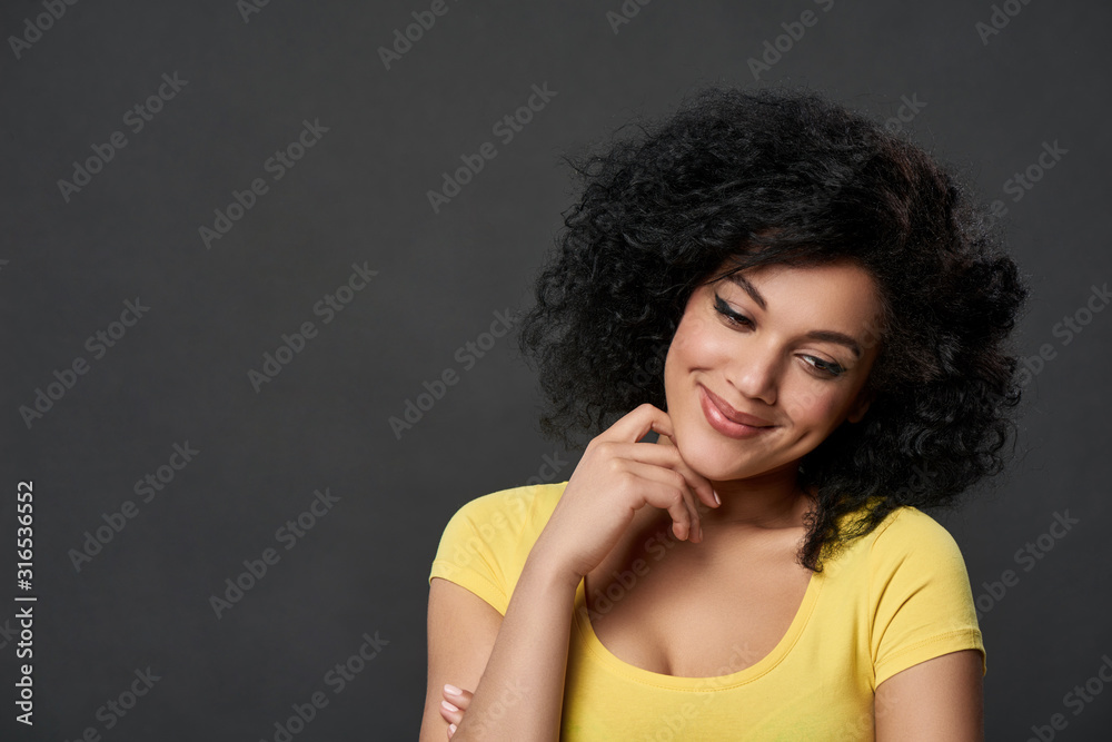 happy girl with hand on chin looking down in thoughts