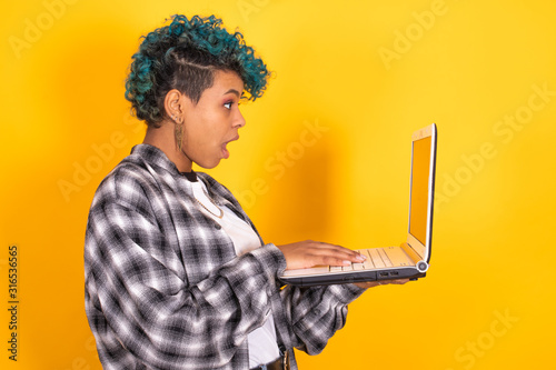 Fotografi woman or girl with laptop computer isolated on color background