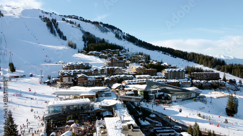 Majestic winter aerial landscape and ski resort with typical alpine wooden houses in French Alps, Les Menuires, 3 Vallees, France, Europe photo