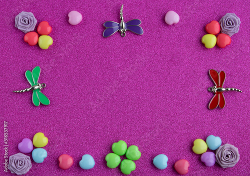 Valentine's day frame. Place for text, copy space.Colorful hearts,paper roses and dragonflies on a pink background.