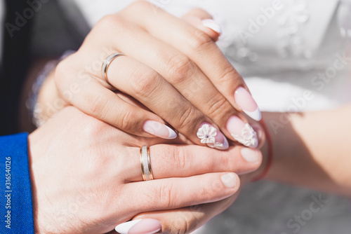  hands of the bride and groom with rings