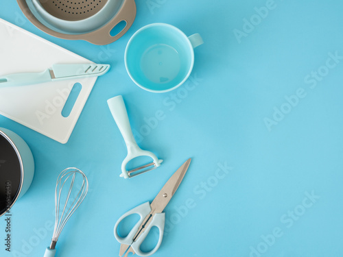 top view of kitchen room concept with kitchenware on blue table background.