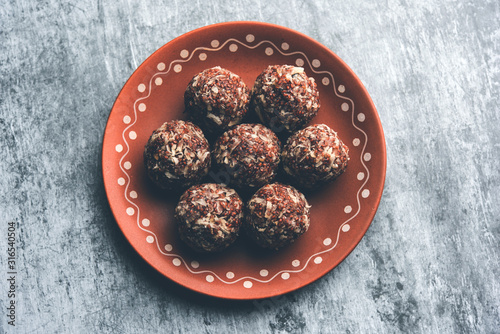 Aliv Laddu, Halim Ladoo or Garden cress Seed sweet Balls a very nutritious food in winters or for New Moms. popular food from India. served in a bowl or plate photo