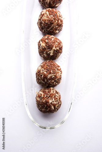 Aliv Laddu, Halim Ladoo or Garden cress Seed sweet Balls a very nutritious food in winters or for New Moms. popular food from India. served in a bowl or plate photo