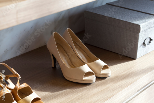 woman hight heel shoe in a shelf with boxes.