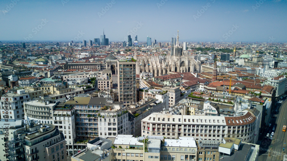 Aerial video shooting with drone on Milan Center, the central business area of the city with new skyscrapers and iconic Cathedral and square of Duomo