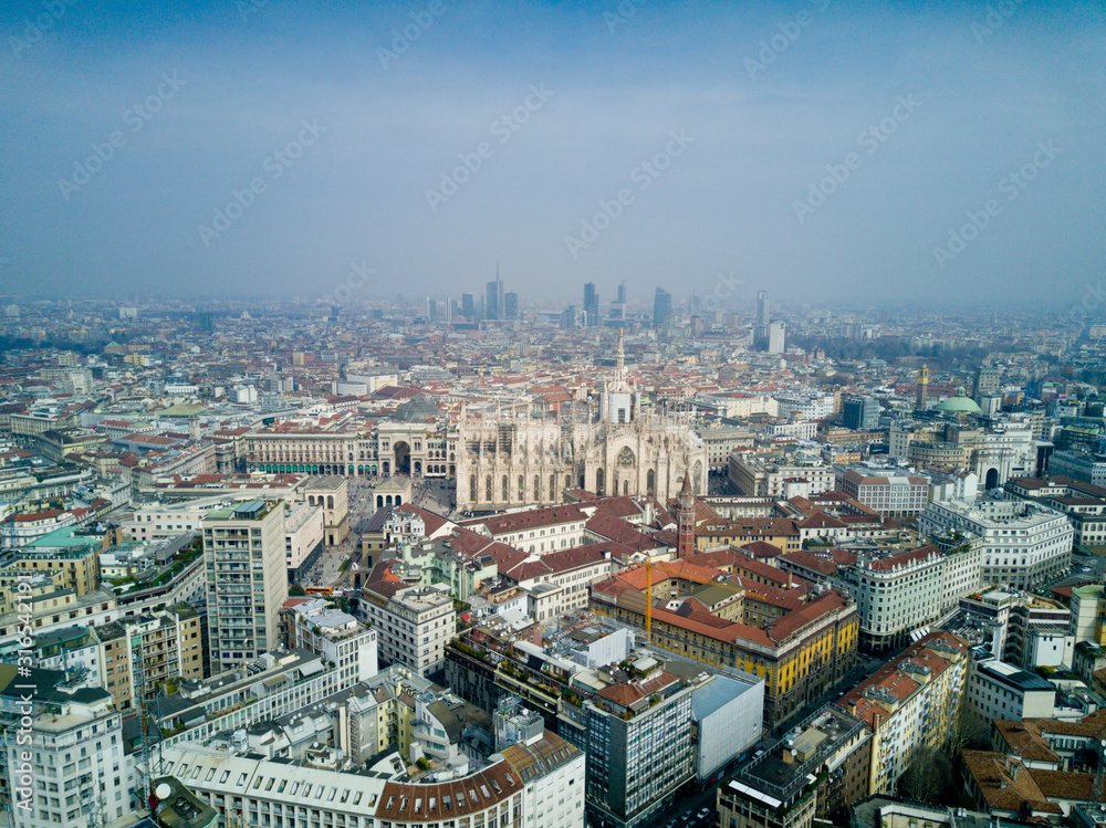 Aerial video shooting with drone on Milan Center, the central business area of the city with new skyscrapers and iconic Cathedral and square of Duomo
