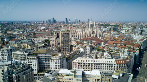 Aerial video shooting with drone on Milan Center, the central business area of the city with new skyscrapers and iconic Cathedral and square of Duomo