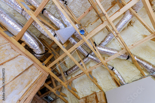 Fotografie Installation of HVAC tubing vents heating system on the roof installing roof is