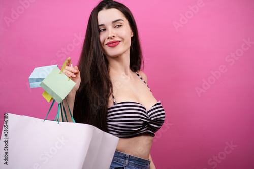 holiday shopping, summer season sale, special offer, store concept. young happy woman holding many shopping bags with goods