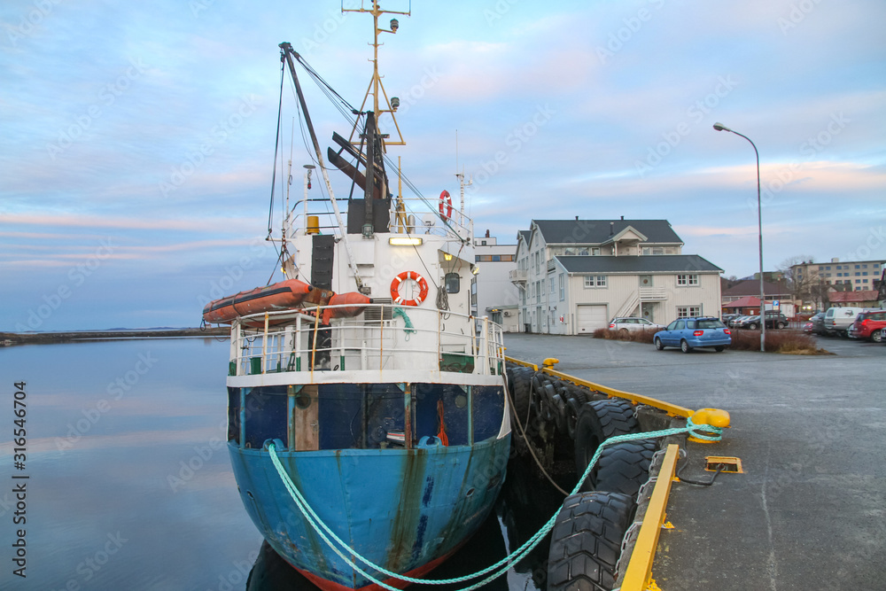 Naklejka premium Old cargo boat at quay in Brønnøysund harbor, Nordland