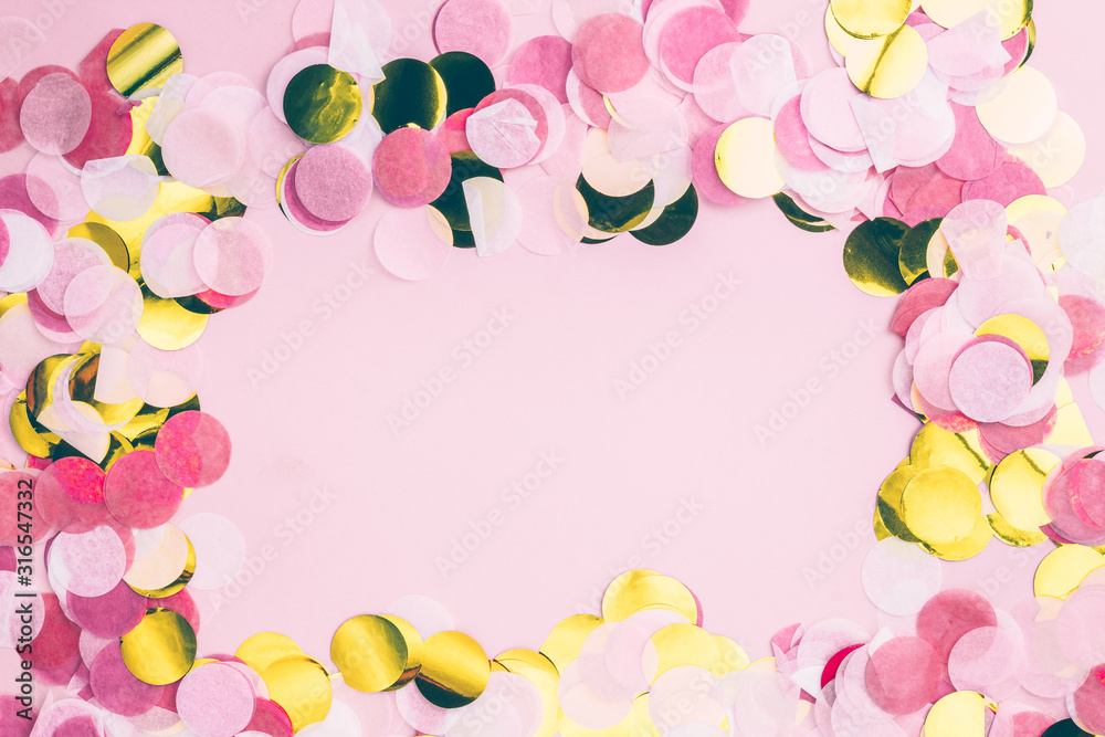 Pink and gold confetti on pink background. Festive holiday pastel backdrop. Flat lay. Top view. Copy space Pink and gold confetti on pink background. Festive holiday pastel backdrop. Flat lay. Top view. Copy space
