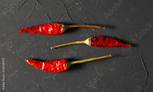 dry chili peppers on a dark background