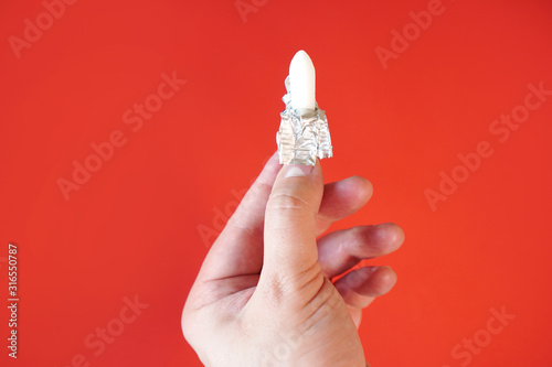 Hemorrhoid. Toilet addiction idea with antihemorrhoids suppositories in the hand. photo