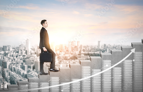 Business man climbing up stair steps to career success with business district and horizon skyline as background Fototapeta