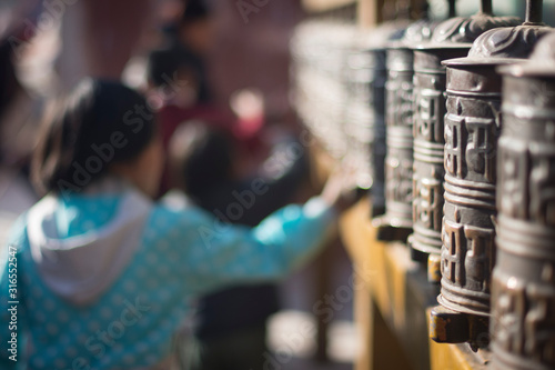 Children spinning prayer wheels in kathmandu, Nepal