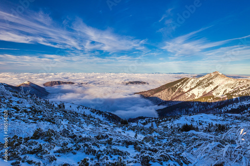 Winter mountain landscape at a sunny day with fog in the valleys. The Mala Fatra national park in Slovakia, Europe.