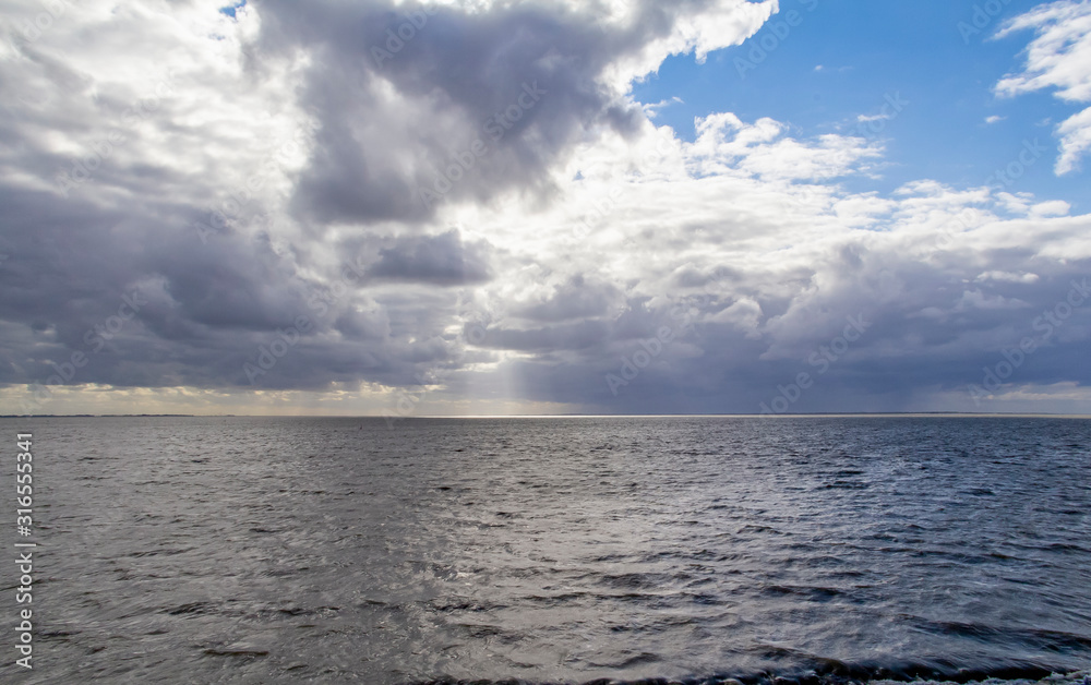 Obraz premium dramatic illuminated coastal scenery in Eastern Frisia