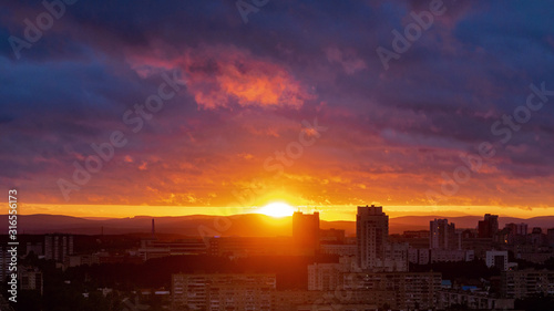 Cuadro en lienzo Sunset timelapse clouds colorful and building photo