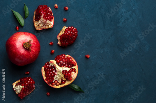 Juicy pomegranate on a blue background with place for text