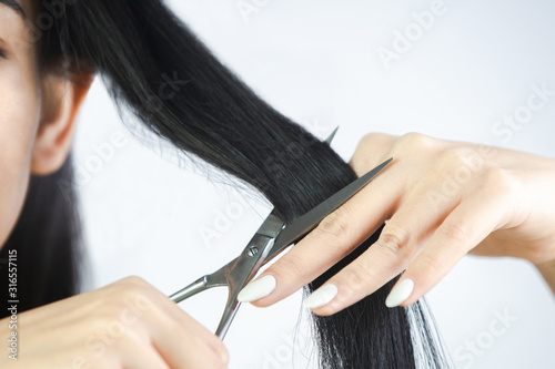 Woman cutting her long hair.