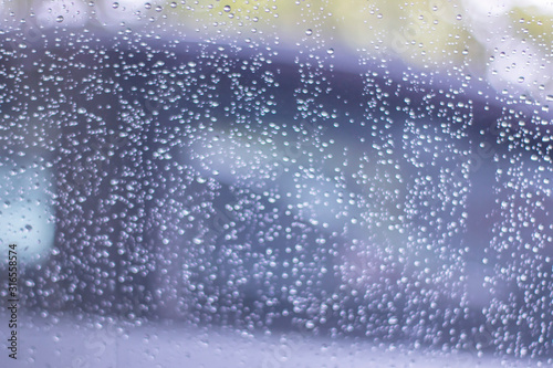 Blurred, raindrops, perched on a glass after a rain background image