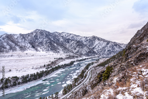 Landscape with snow-capped mountains and mountain river