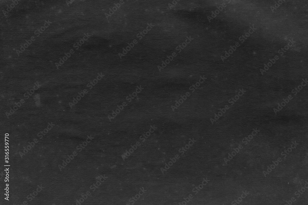 Fototapeta premium Cardboard black abstract texture close-up. Dark old paper background. Grunge concrete wall. Vintage blank wallpaper.