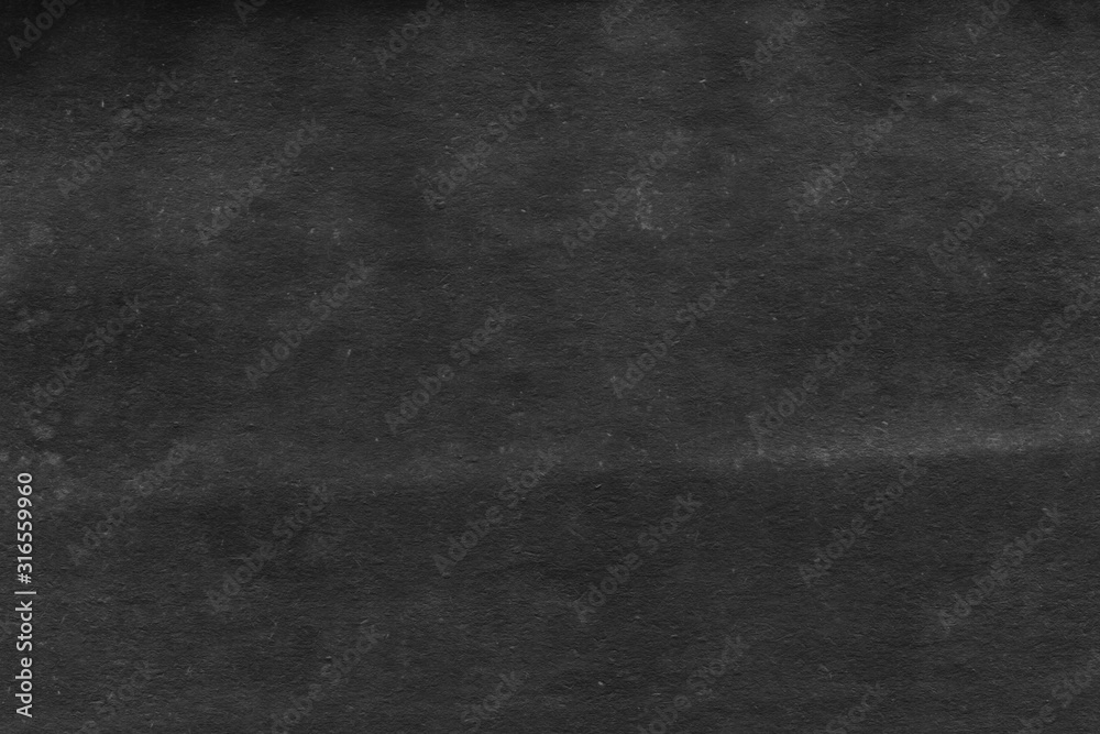 Fototapeta premium Cardboard black abstract texture close-up. Dark old paper background. Grunge concrete wall. Vintage blank wallpaper.