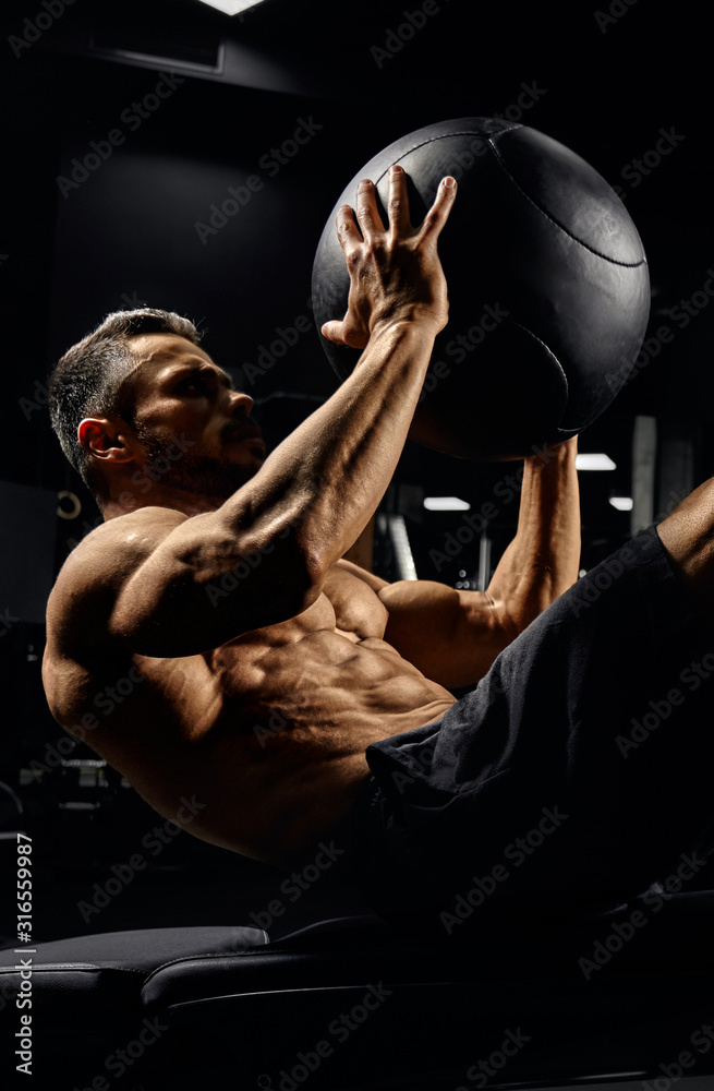 Man building core muscles with ball.