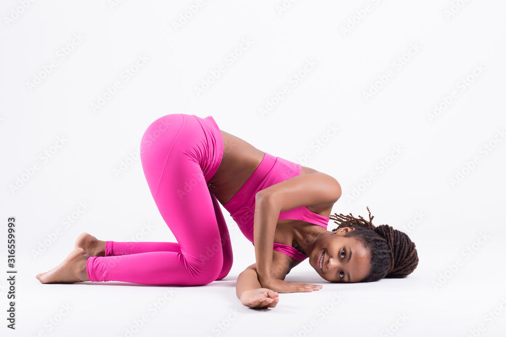 Obraz premium Pretty young black woman doing yoga exercise isolated on white background