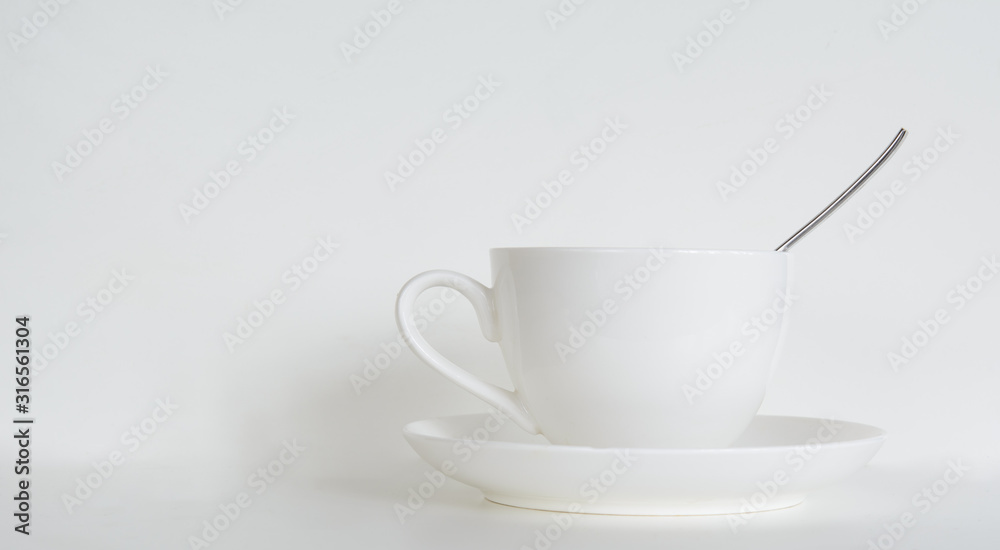 coffee cup with saucer and a teaspoon on a white background. Concept - cafe, restaurant. Copy space