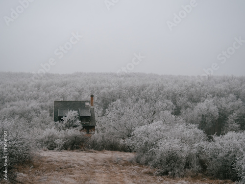 Frozen landscape with abandoned house © Laszlo