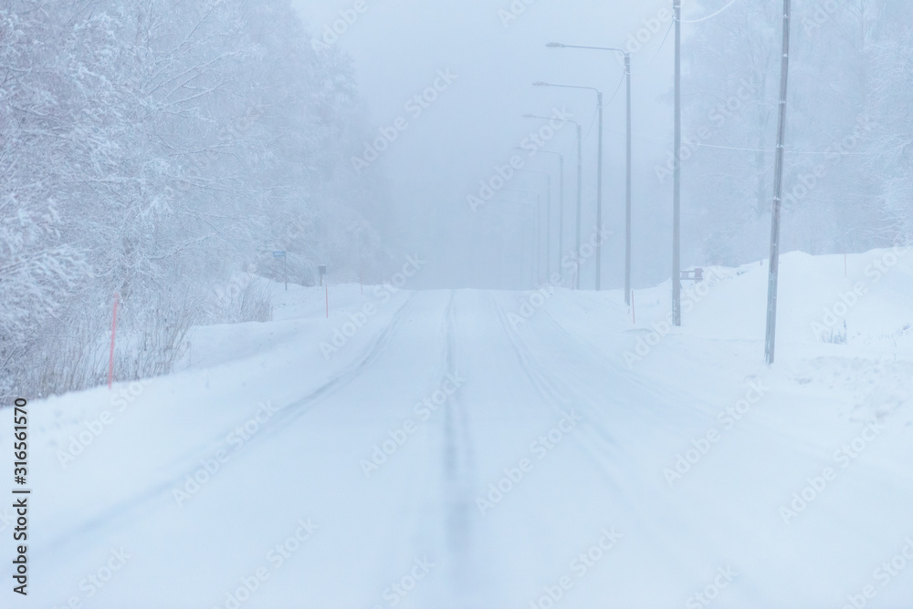 The road number 496 has covered with heavy snow and bad weather in winter season at Tuupovaara, Finland. The road number 496 has covered with heavy snow and bad weather in winter season at Tuupovaara, Finland.
