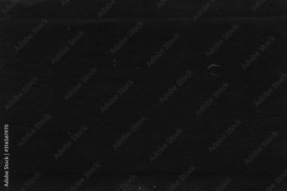 Fototapeta premium Cardboard black abstract texture close-up. Dark old paper background. Grunge concrete wall. Vintage blank wallpaper.