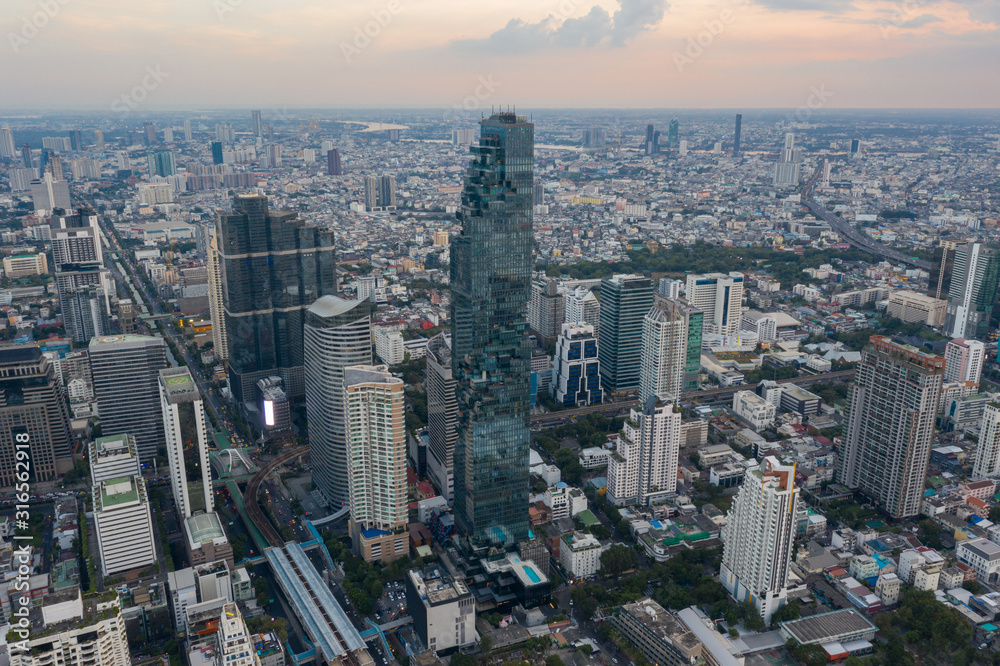 Fototapeta premium beautiful city view at twilight scene City scape of MahaNakhon building, skyscraper in the Silom/Sathon central business district of Bangkok as the tallest building in Thailand