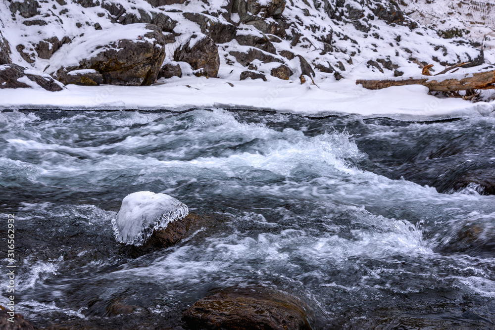 water flow of a freezing mountain river water flow of a freezing mountain river