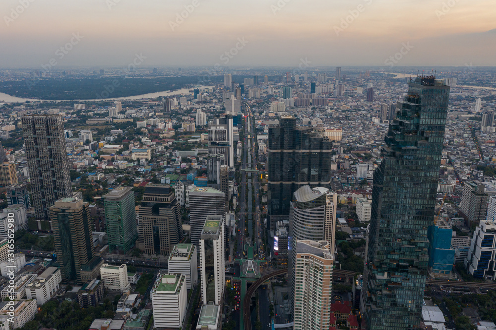 Fototapeta premium beautiful city view at twilight scene City scape of MahaNakhon building, skyscraper in the Silom/Sathon central business district of Bangkok as the tallest building in Thailand