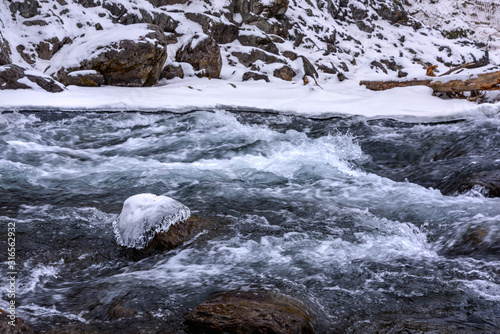 water flow of a freezing mountain river