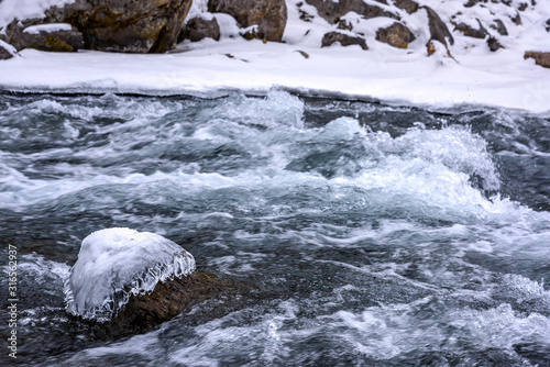 water flow of a freezing mountain river