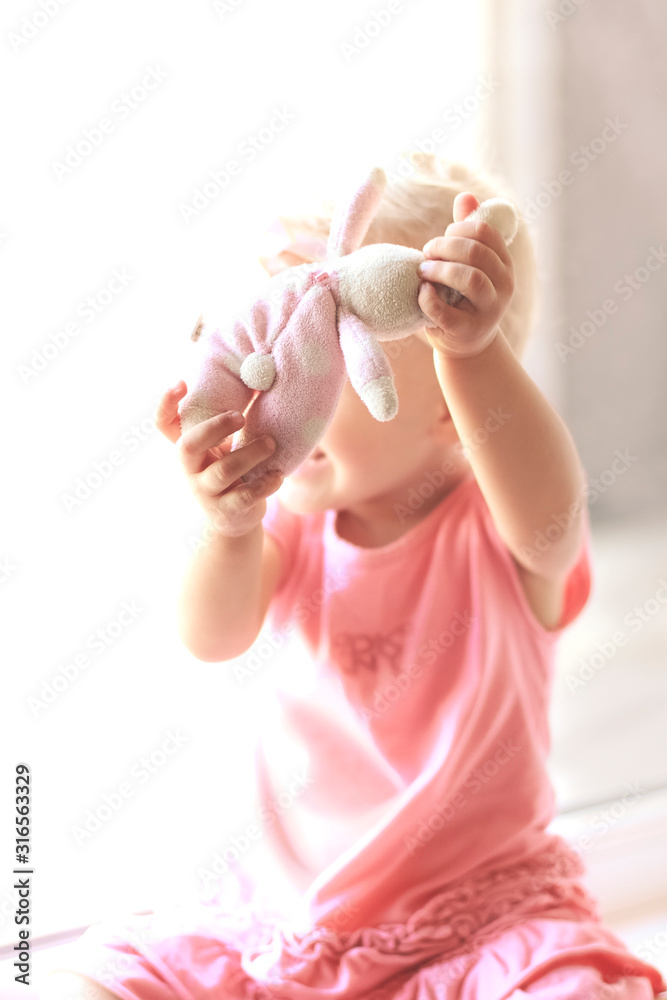 Naklejka premium Baby girl with toy