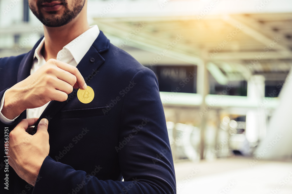 Investor beard guy showing bitcoin in a city. White collar worker put bitcoin to suit pocket. Young business man is bitcoin mining, can earn a lot of money. Future money and life with bitcoin concept Investor beard guy showing bitcoin in a city. White collar worker put bitcoin to suit pocket. Young business man is bitcoin mining, can earn a lot of money. Future money and life with bitcoin concept