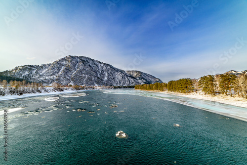 Landscape with snow-capped mountains and mountain river